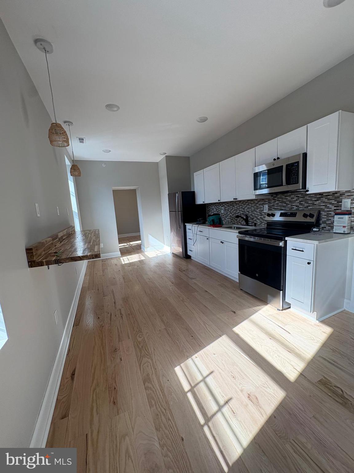 2900 North 5th Street, Unit 2 Philadelphia, PA 19133 - Photo 7 of 8 a large kitchen with stainless steel appliances granite countertop a stove and a sink