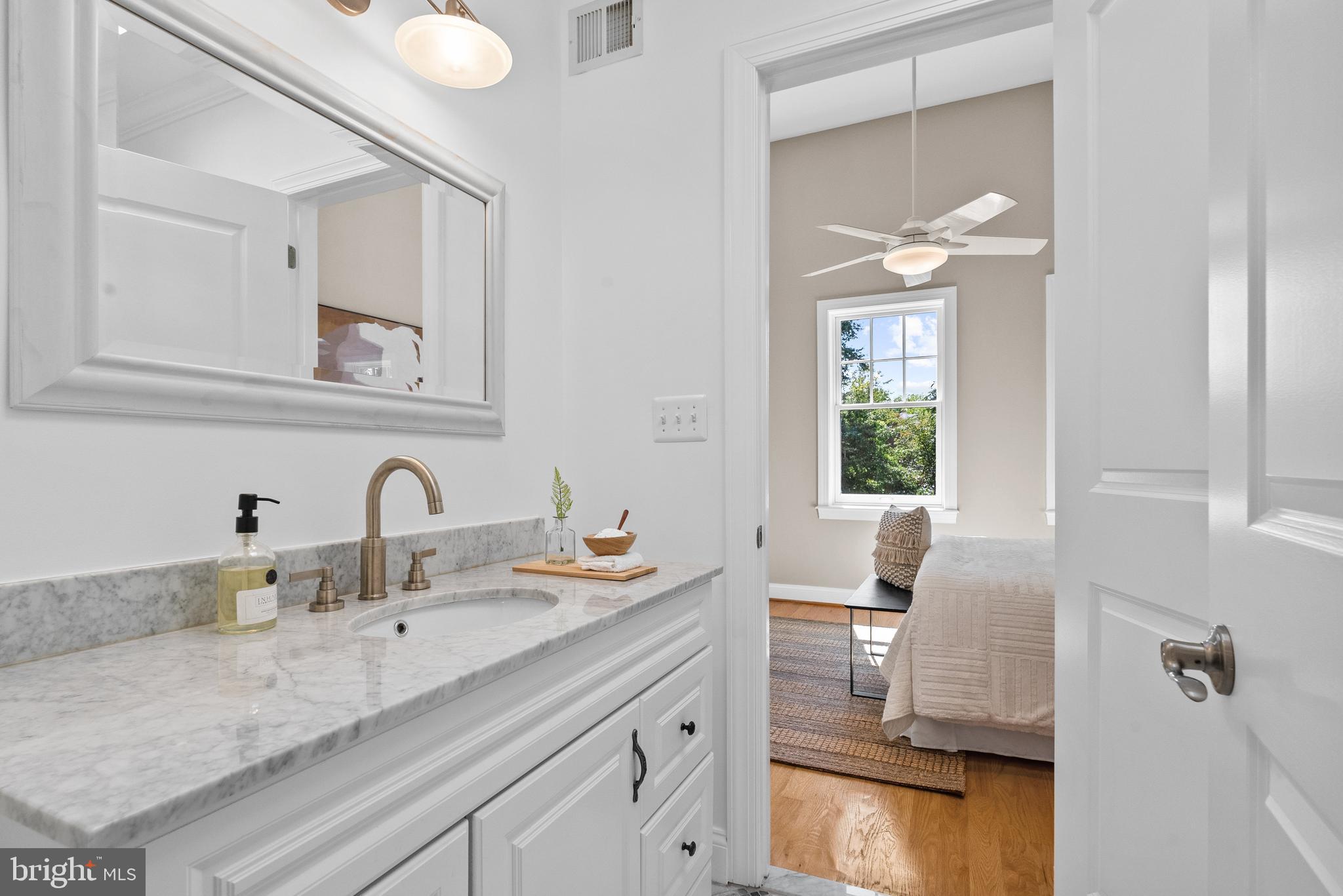 610 Independence Avenue Southeast Washington, DC 20003 - Photo 18 of 26 a en suite bathroom with a granite countertop sink and a mirror