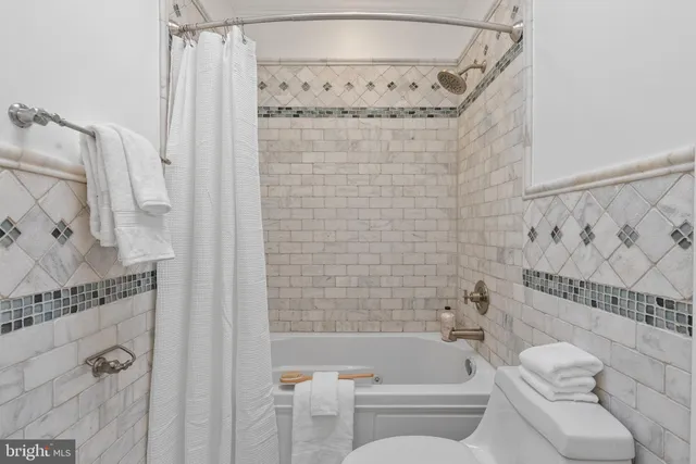 a bedroom with a large bed and a painting on the wall