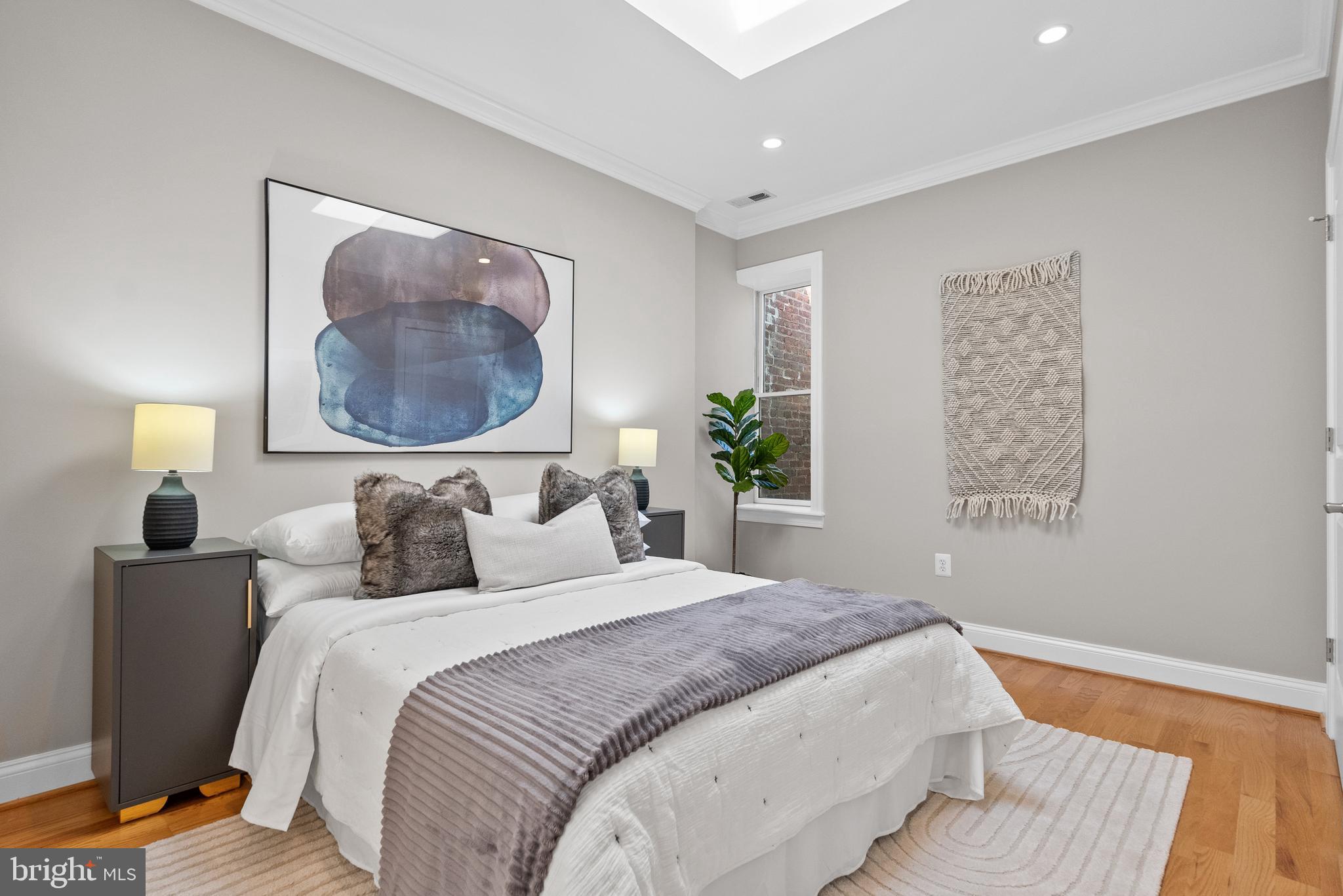 610 Independence Avenue Southeast Washington, DC 20003 - Photo 20 of 26 a bedroom with a large bed and a painting on the wall