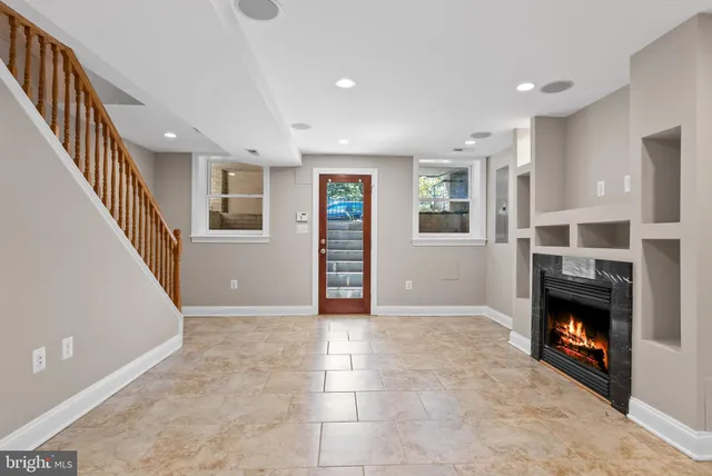 a view of a kitchen with stainless steel appliances granite countertop a refrigerator and a sink