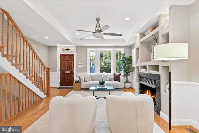 a dining room with wooden floor a chandelier a wooden table and chairs