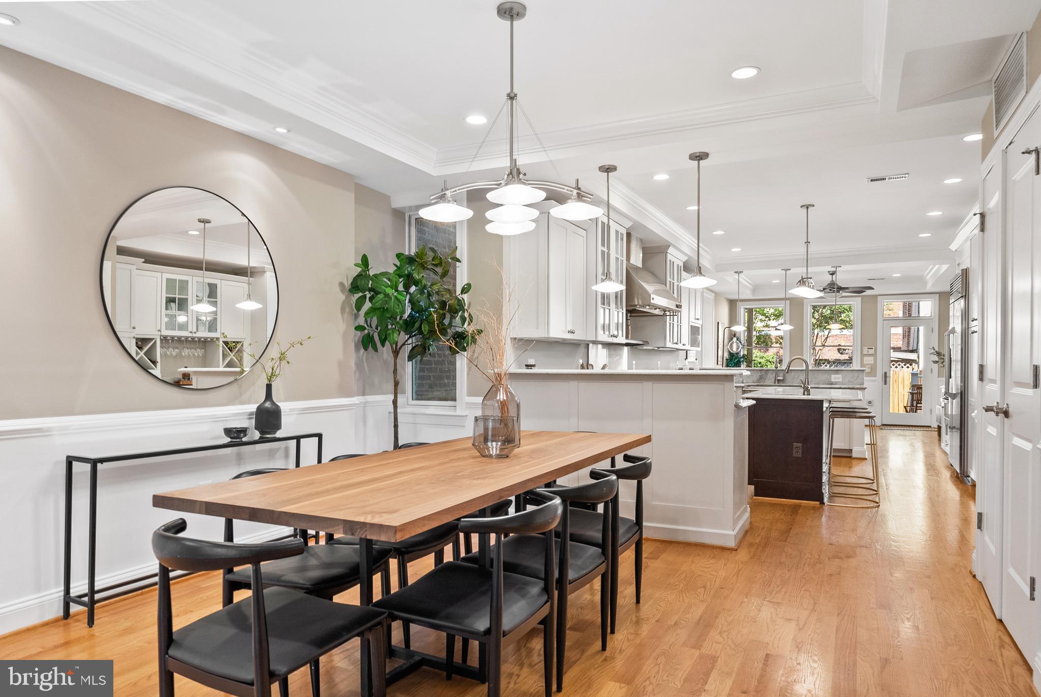 610 Independence Avenue Southeast Washington, DC 20003 - Photo 4 of 26 a dining room with wooden floor a chandelier a wooden table and chairs