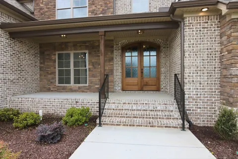 a front view of a house with a garden