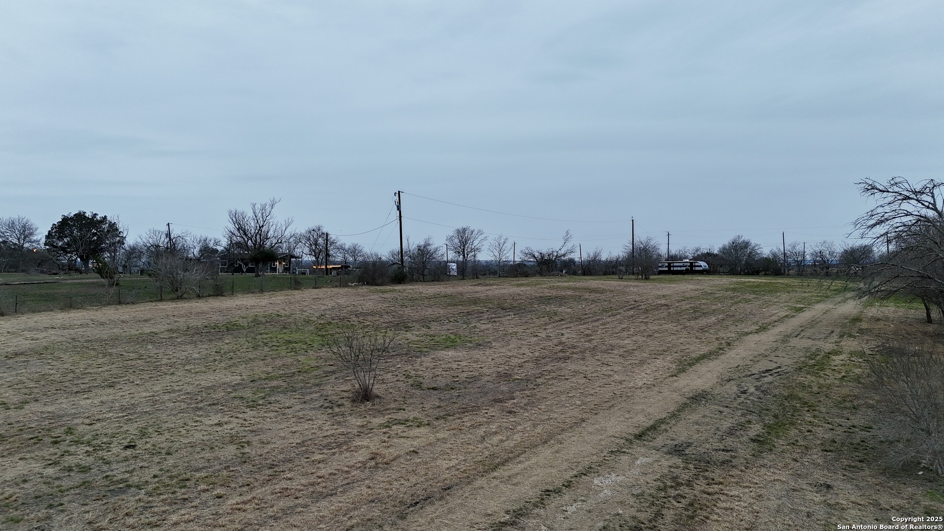 6759 Pfeil Road Schertz, TX 78154 - Photo 5 of 8 a view of a field with trees in background