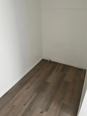 an empty room with wooden floor