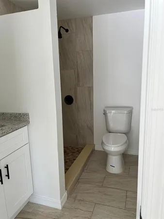 a bathroom with a toilet and a shower