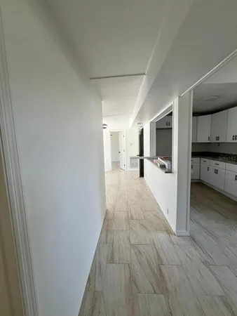 a view of a kitchen with wooden floor