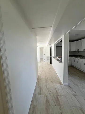 a view of a kitchen with wooden floor