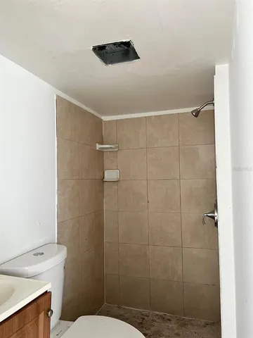 a bathroom with a shower toilet and sink