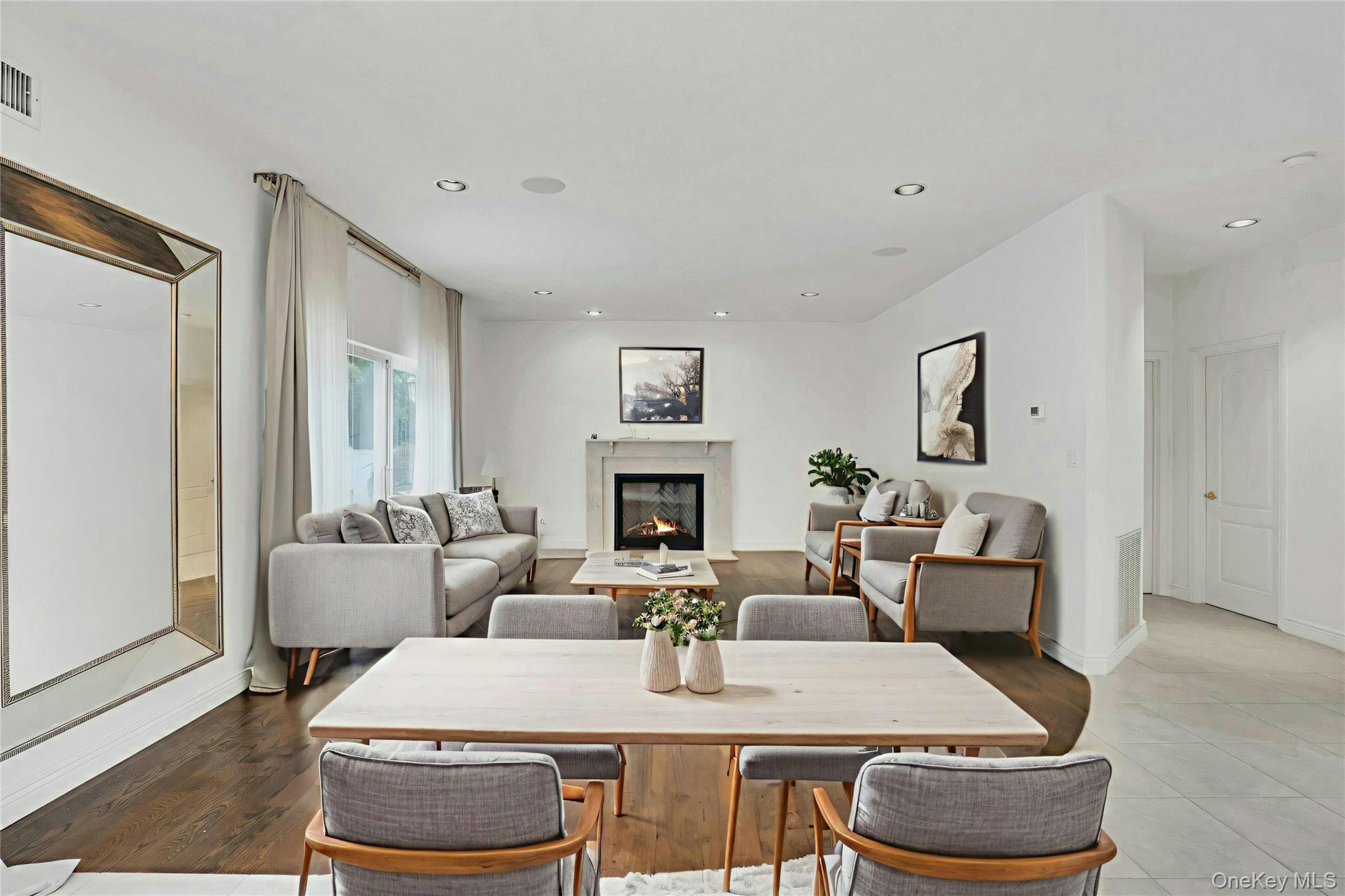 2 Wisteria Lane Lake Grove, NY 11755 - Photo 12 of 43 a view of a dining room with furniture a fireplace and wooden floor