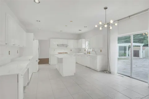 a view of a kitchen with white cabinets