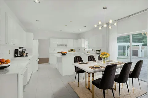 a kitchen that has a table and chairs in it