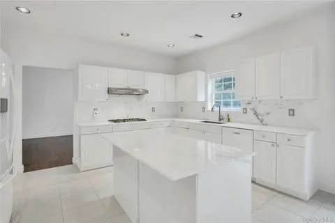 a kitchen with stainless steel appliances a sink stove and cabinets