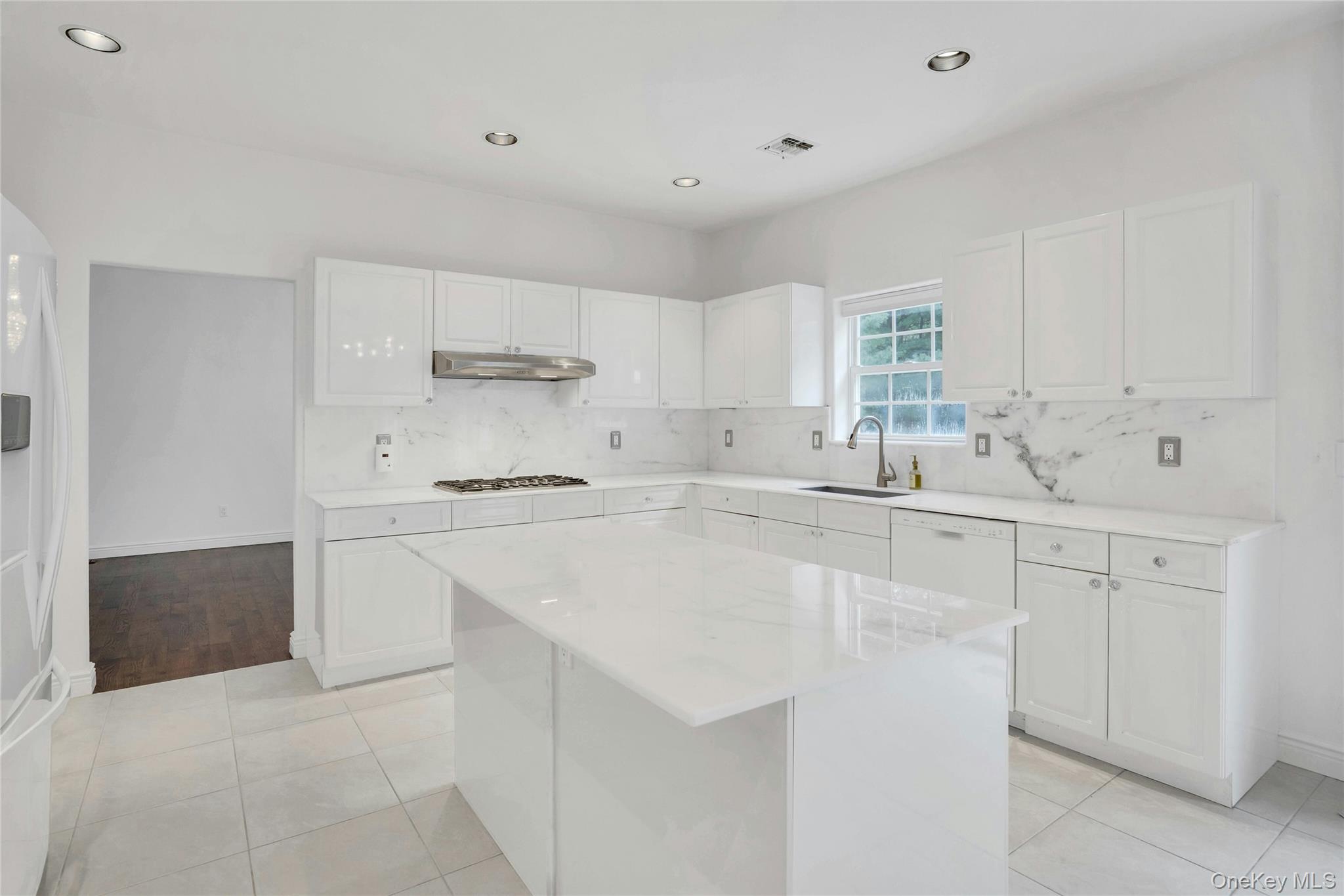 2 Wisteria Lane Lake Grove, NY 11755 - Photo 16 of 43 a kitchen with stainless steel appliances a sink stove and cabinets
