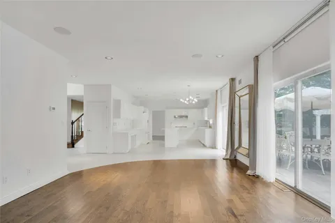 a view of a big room with wooden floor and a bathroom