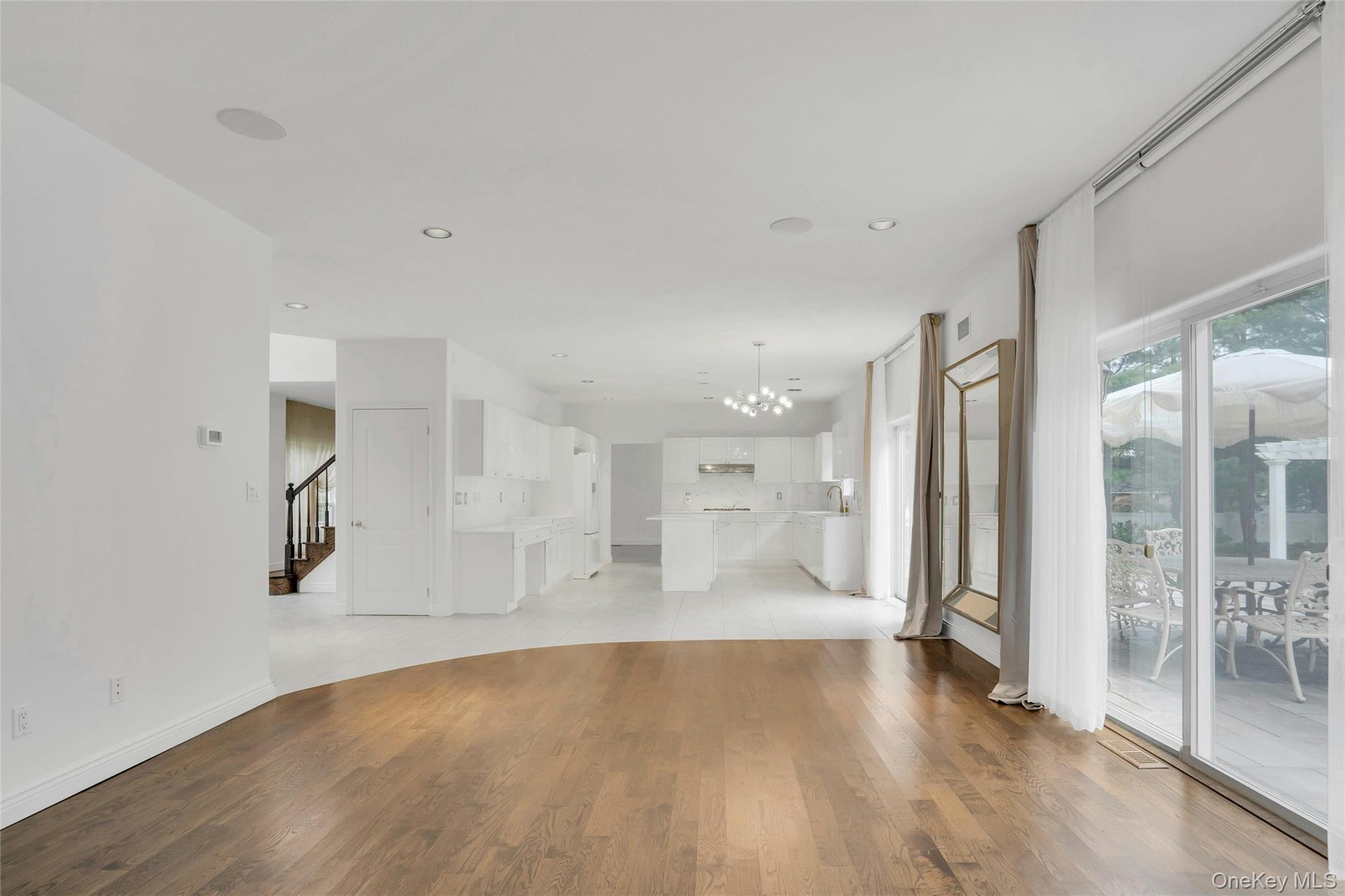 2 Wisteria Lane Lake Grove, NY 11755 - Photo 17 of 43 a view of a big room with wooden floor and a bathroom