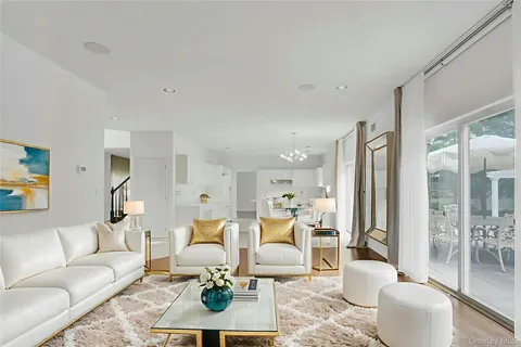 a living room with furniture a rug and a large window