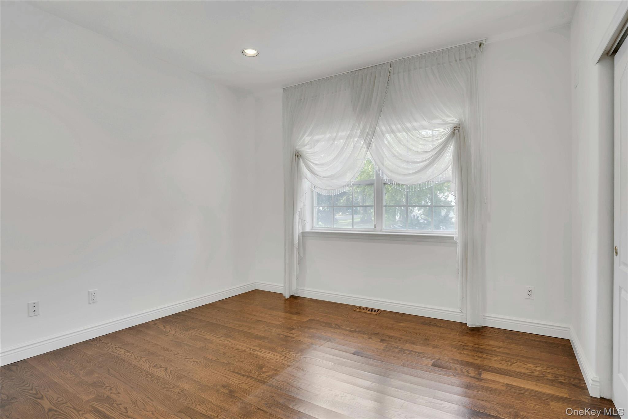 2 Wisteria Lane Lake Grove, NY 11755 - Photo 20 of 43 a view of wooden floor and a window in a room