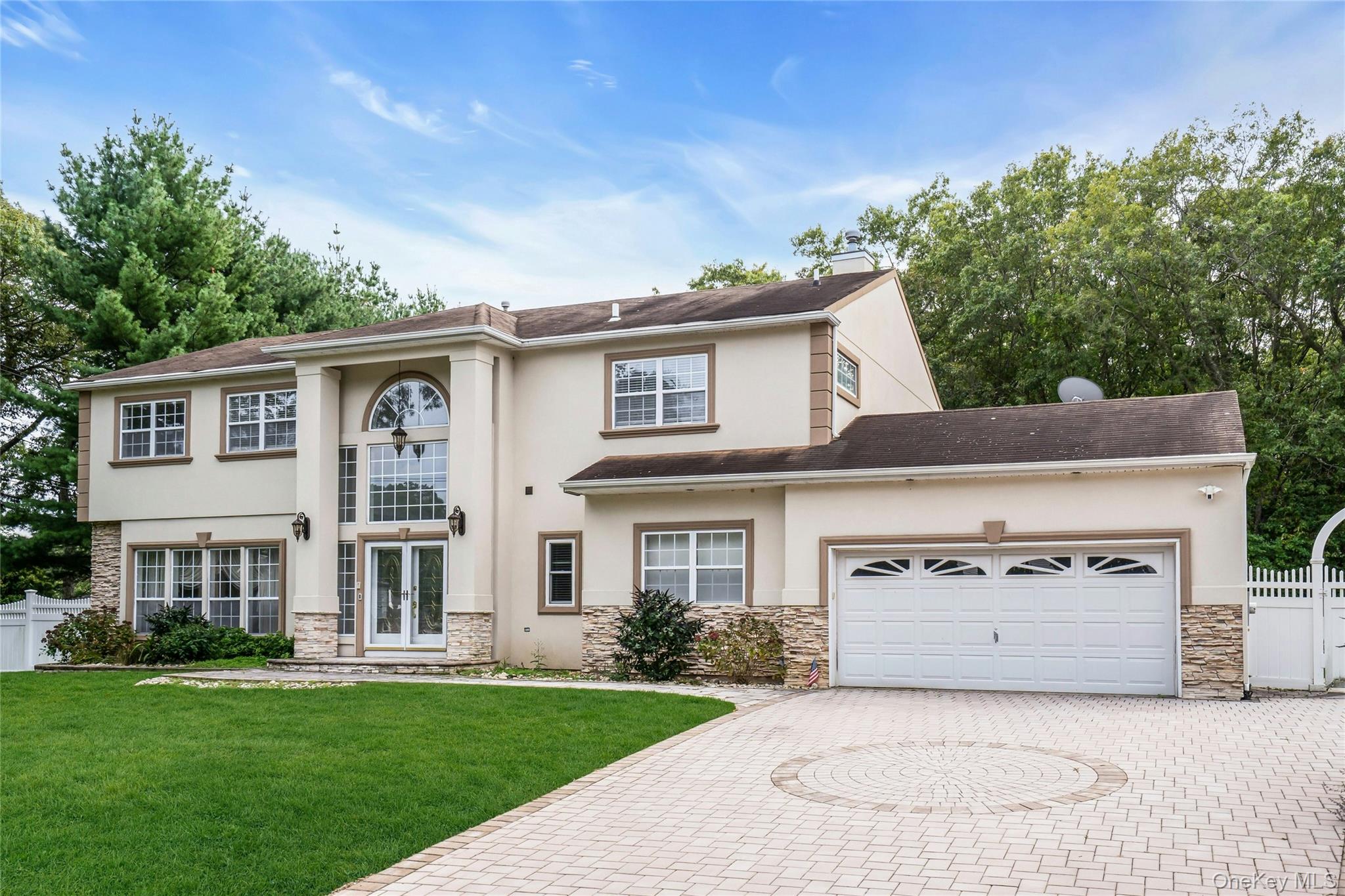 2 Wisteria Lane Lake Grove, NY 11755 - Photo 2 of 43 front view of a house with a garden