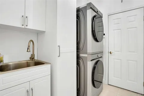 a close view of a sink and washer in a kitchen