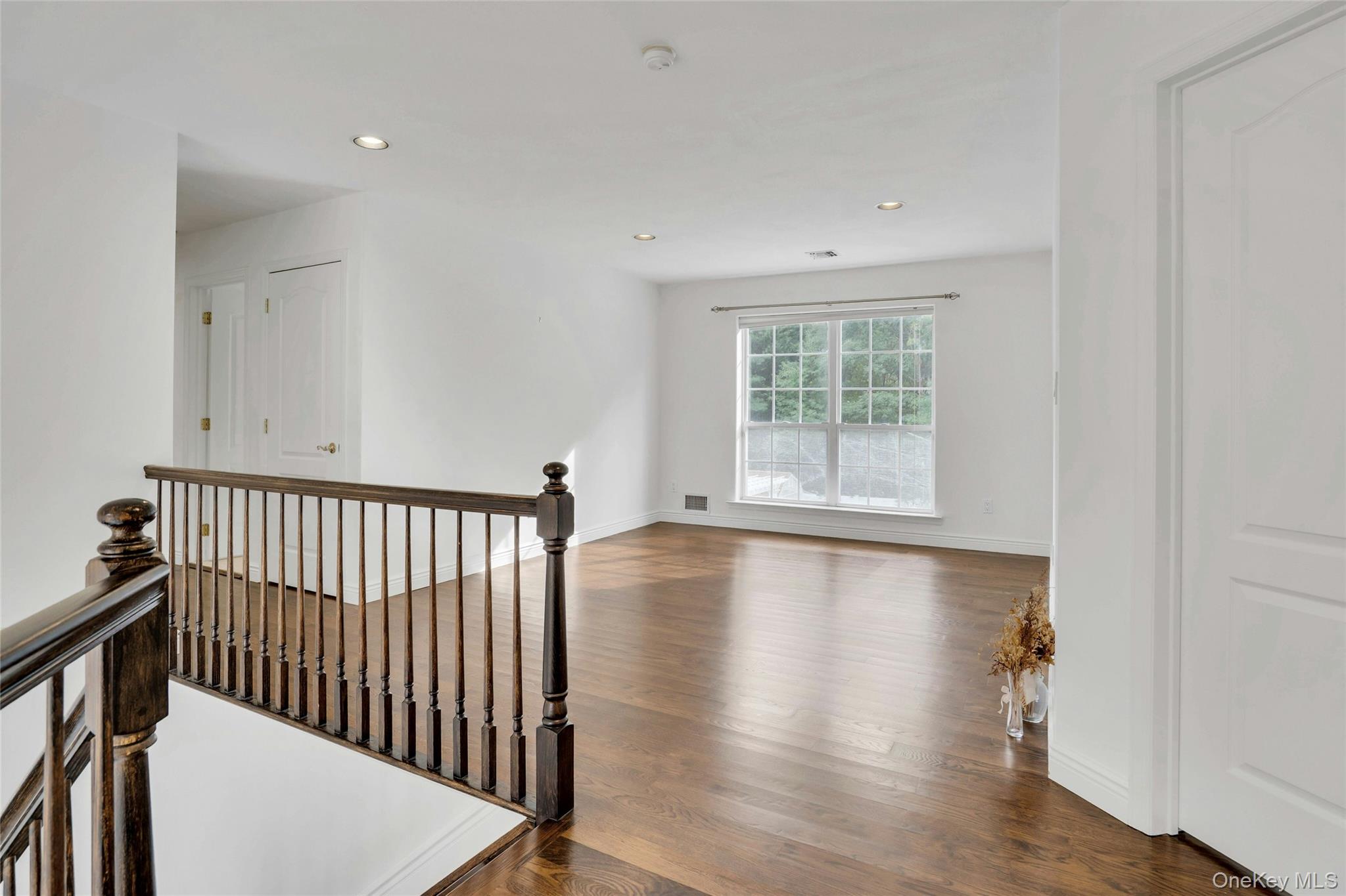 2 Wisteria Lane Lake Grove, NY 11755 - Photo 22 of 43 a view of a room with wooden floor and a window