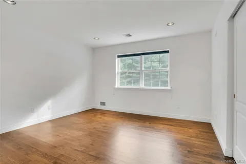 a bedroom with a bed and a potted plant