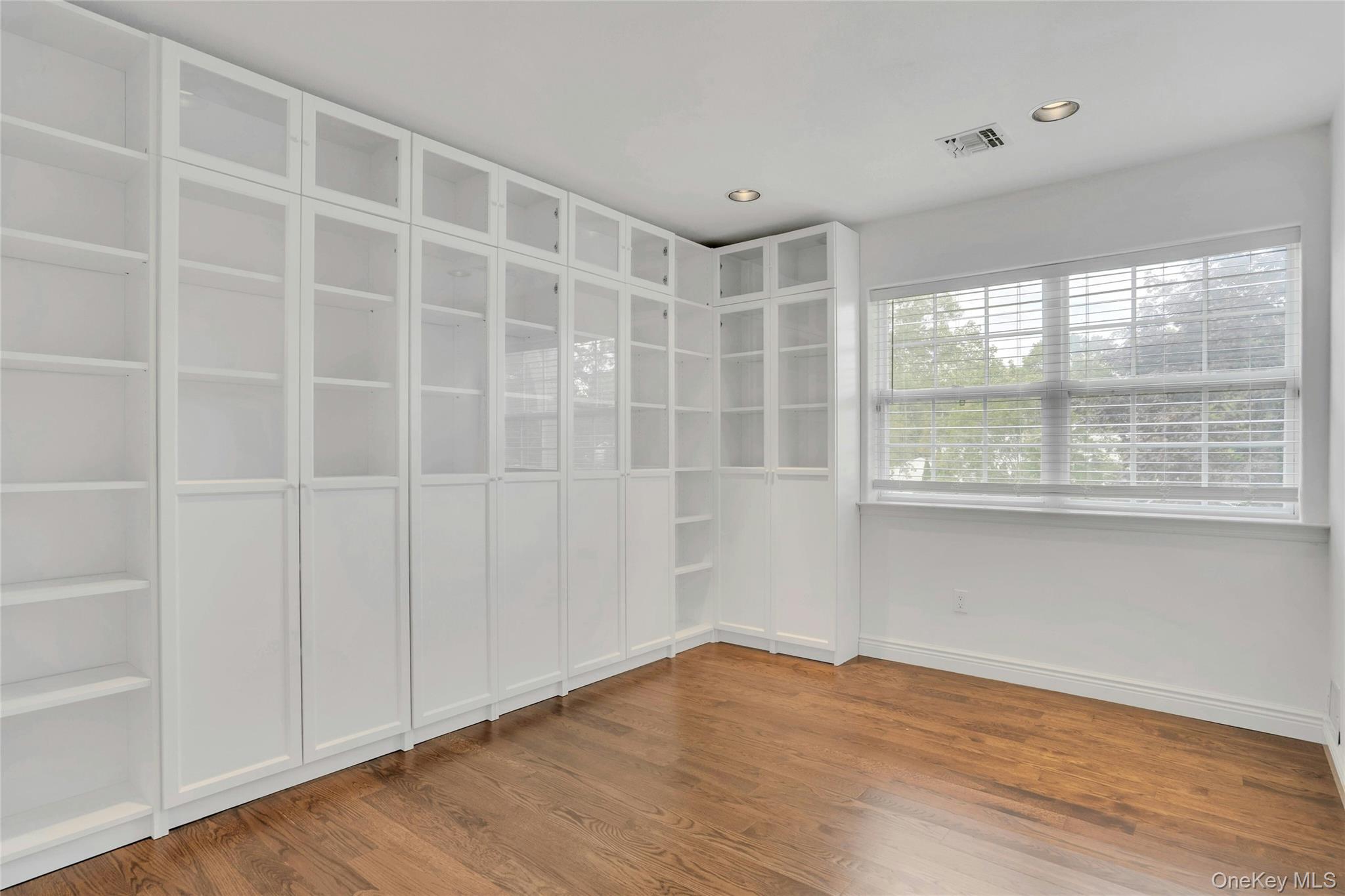 2 Wisteria Lane Lake Grove, NY 11755 - Photo 28 of 43 a view of an empty room with wooden floor and a window