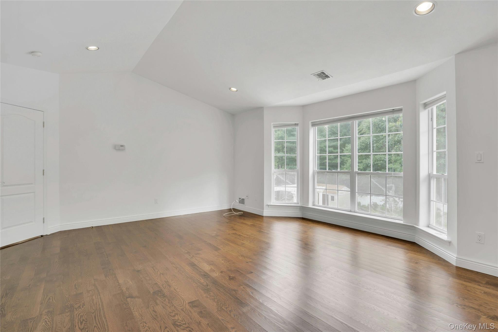 2 Wisteria Lane Lake Grove, NY 11755 - Photo 30 of 43 a view of room with hardwood floor and window