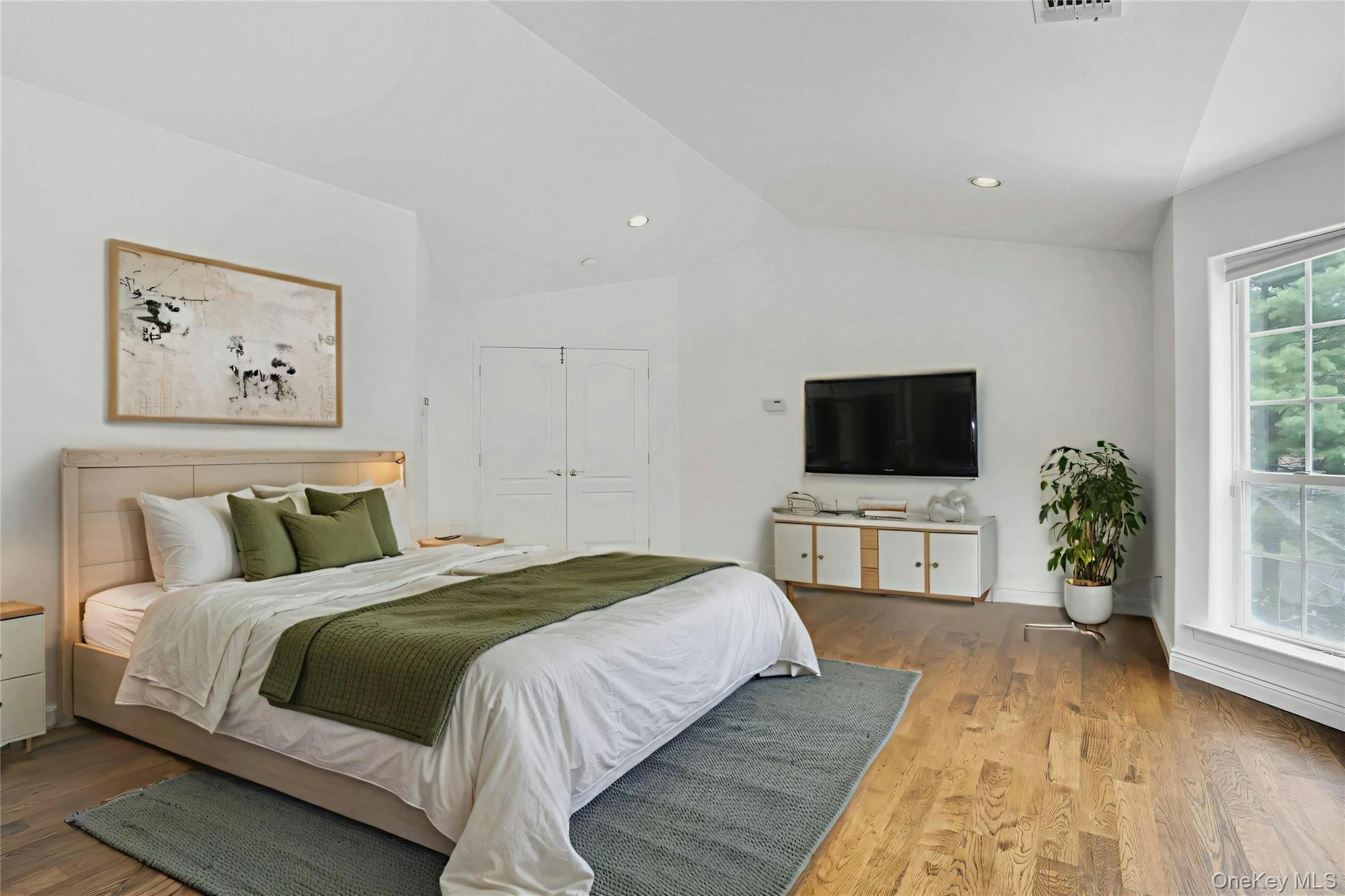 2 Wisteria Lane Lake Grove, NY 11755 - Photo 33 of 43 a bedroom with a bed and a flat screen tv