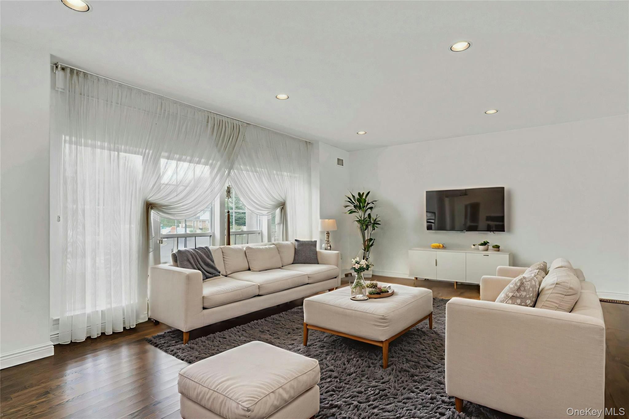 2 Wisteria Lane Lake Grove, NY 11755 - Photo 8 of 43 a living room with furniture and a flat screen tv