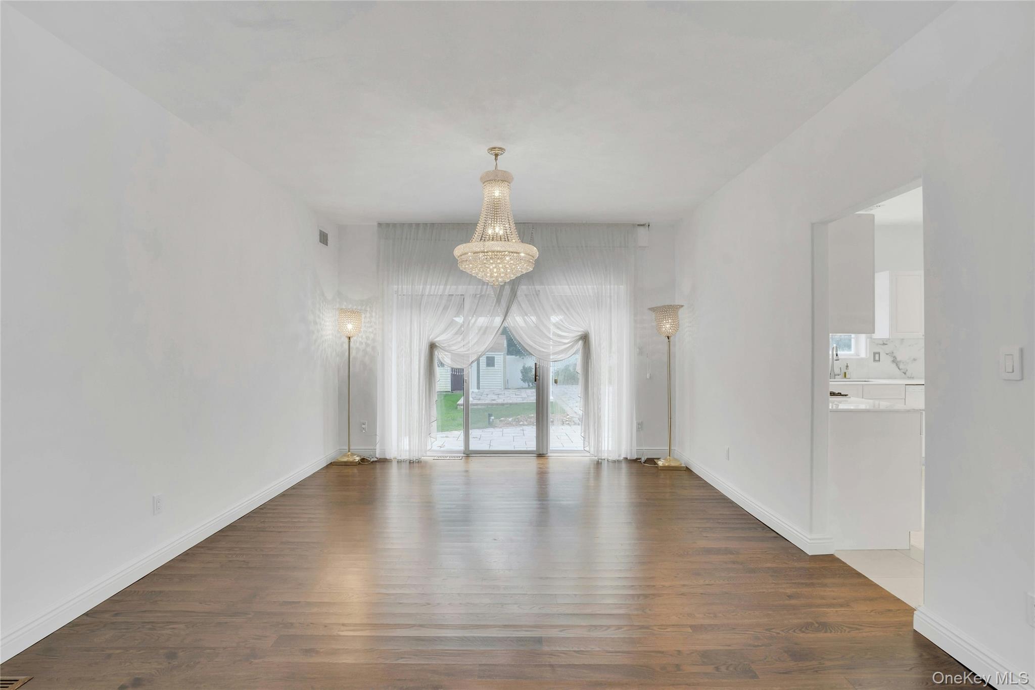2 Wisteria Lane Lake Grove, NY 11755 - Photo 9 of 43 a view of an empty room with wooden floor and a window