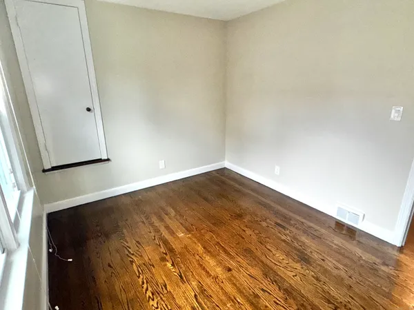 an empty room with wooden floor