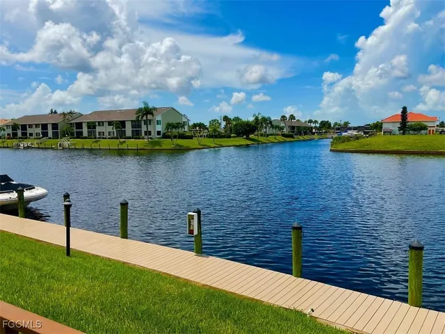 a view of a lake with houses in the back