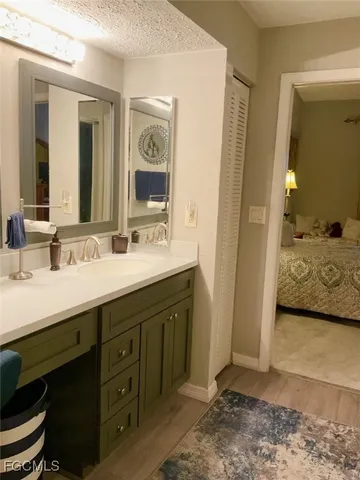 a en suite bathroom with a double vanity sink and a mirror
