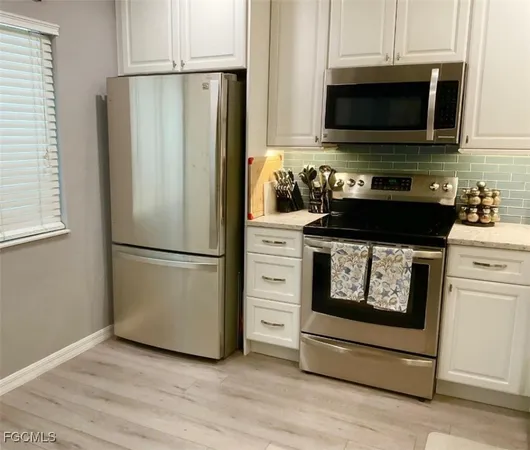 a kitchen with a refrigerator stove and microwave