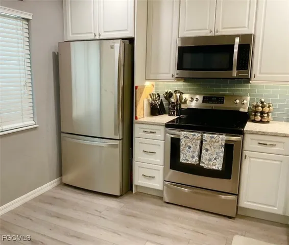 a kitchen with a refrigerator stove and microwave