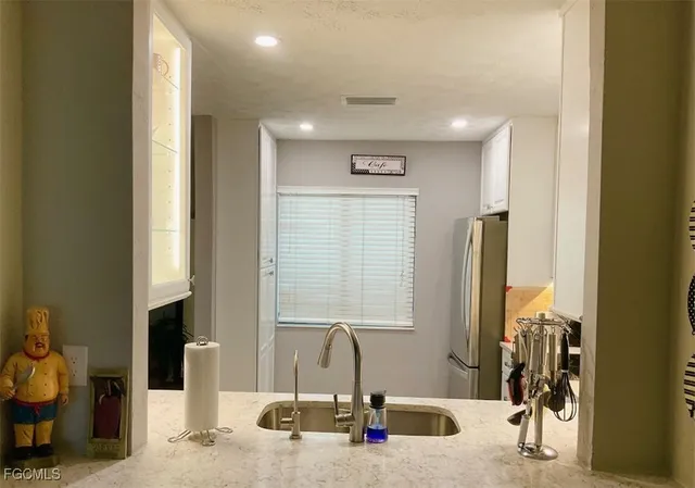 a view of a bathroom with a sink and a mirror