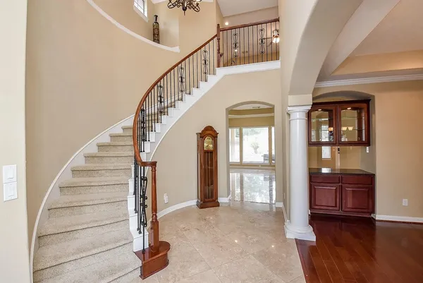 a view of entryway and hall with wooden floor