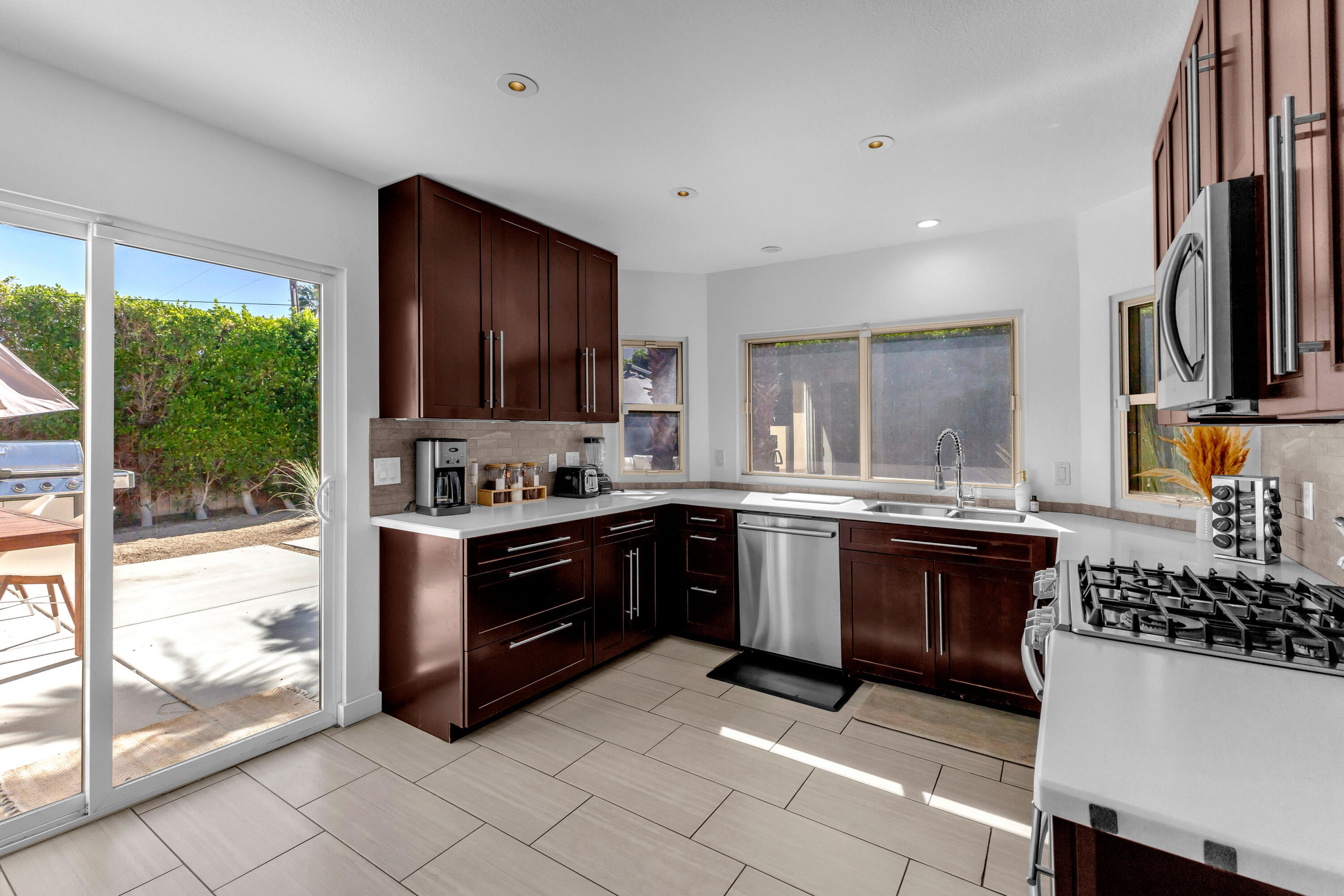 2355 West Nicola Road Palm Springs, CA 92262 - Photo 35 of 54 a kitchen with stainless steel appliances granite countertop a stove a sink and a microwave