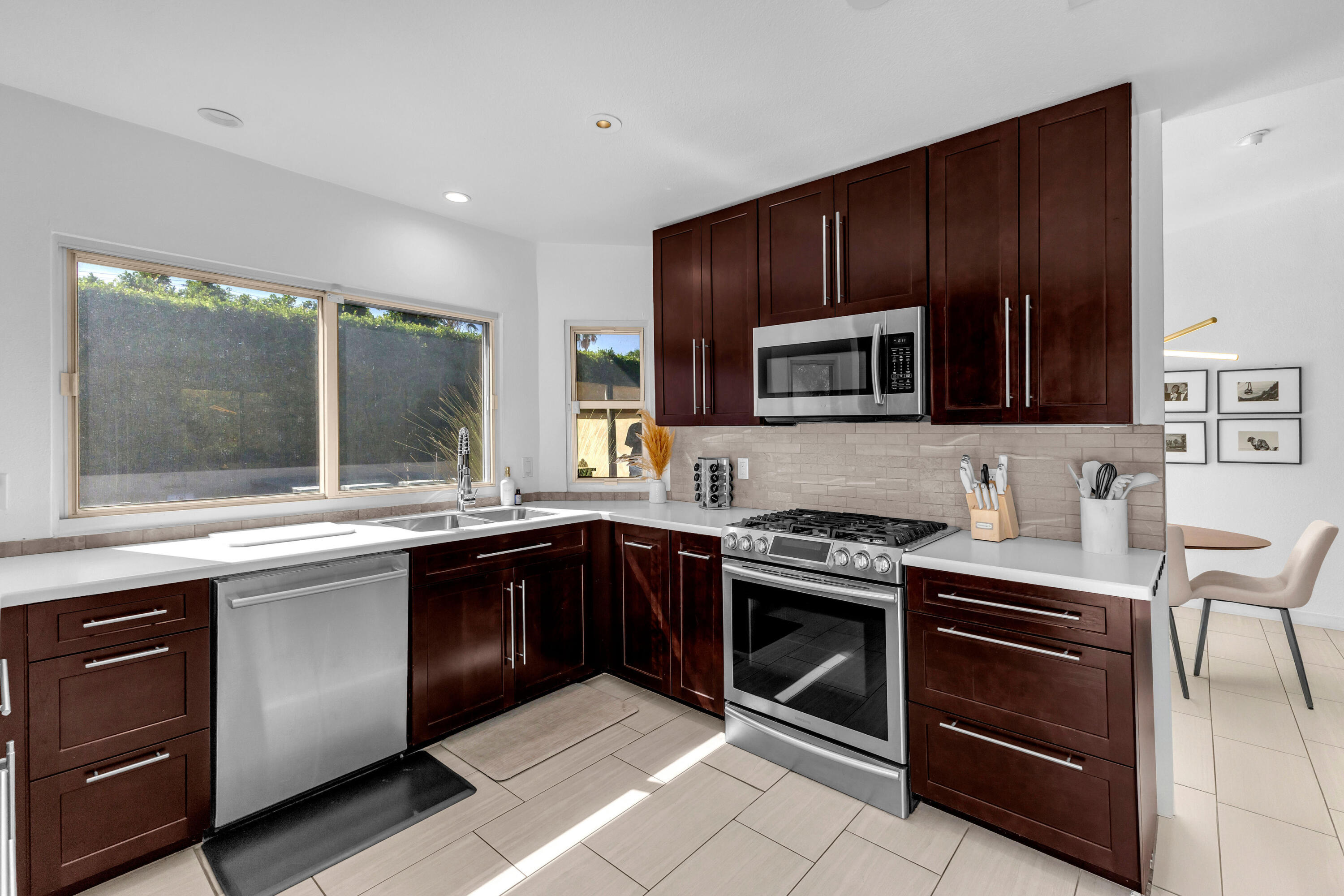 2355 West Nicola Road Palm Springs, CA 92262 - Photo 37 of 54 a kitchen with granite countertop wooden cabinets stainless steel appliances and a window