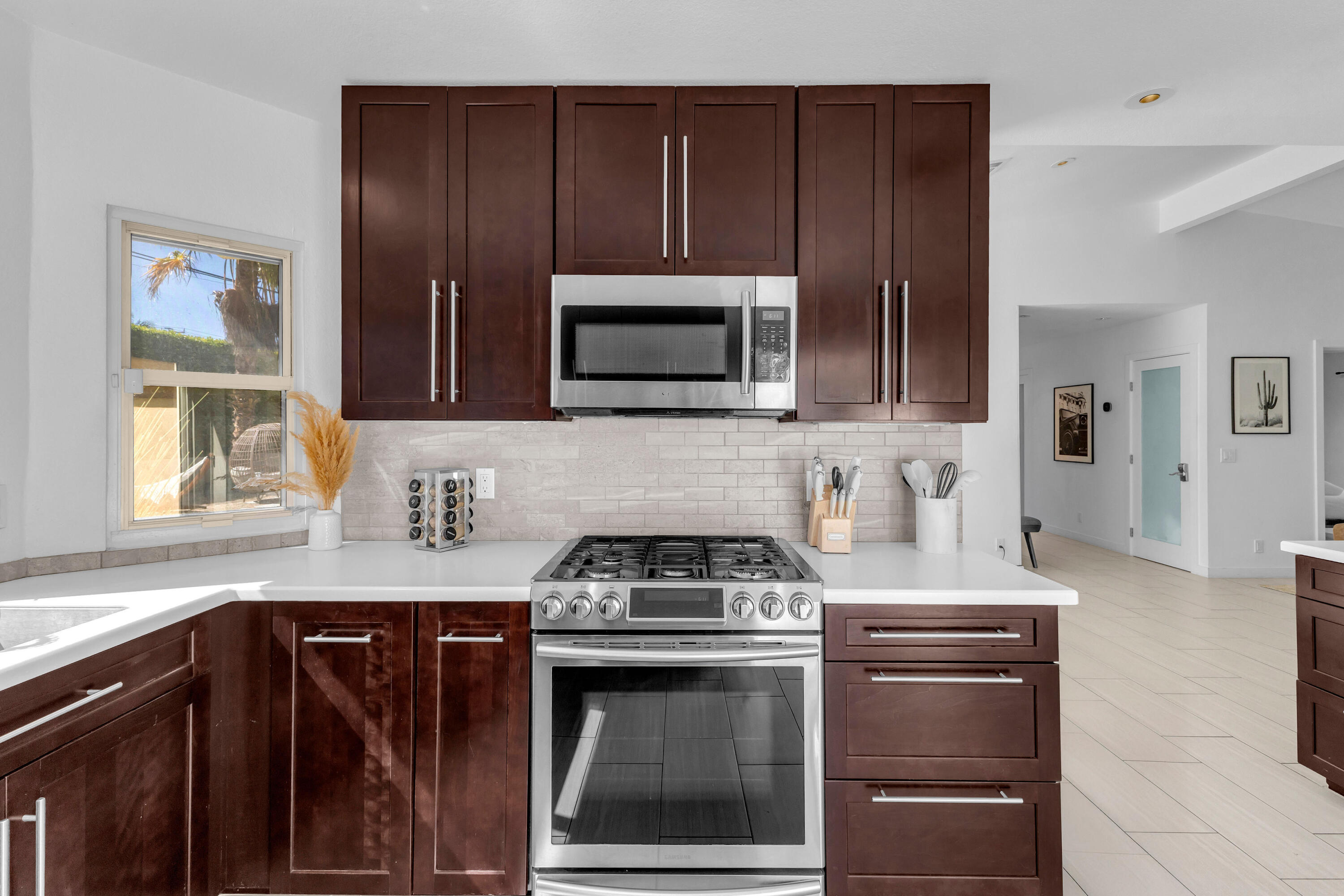 2355 West Nicola Road Palm Springs, CA 92262 - Photo 38 of 54 a kitchen with granite countertop a stove and a microwave