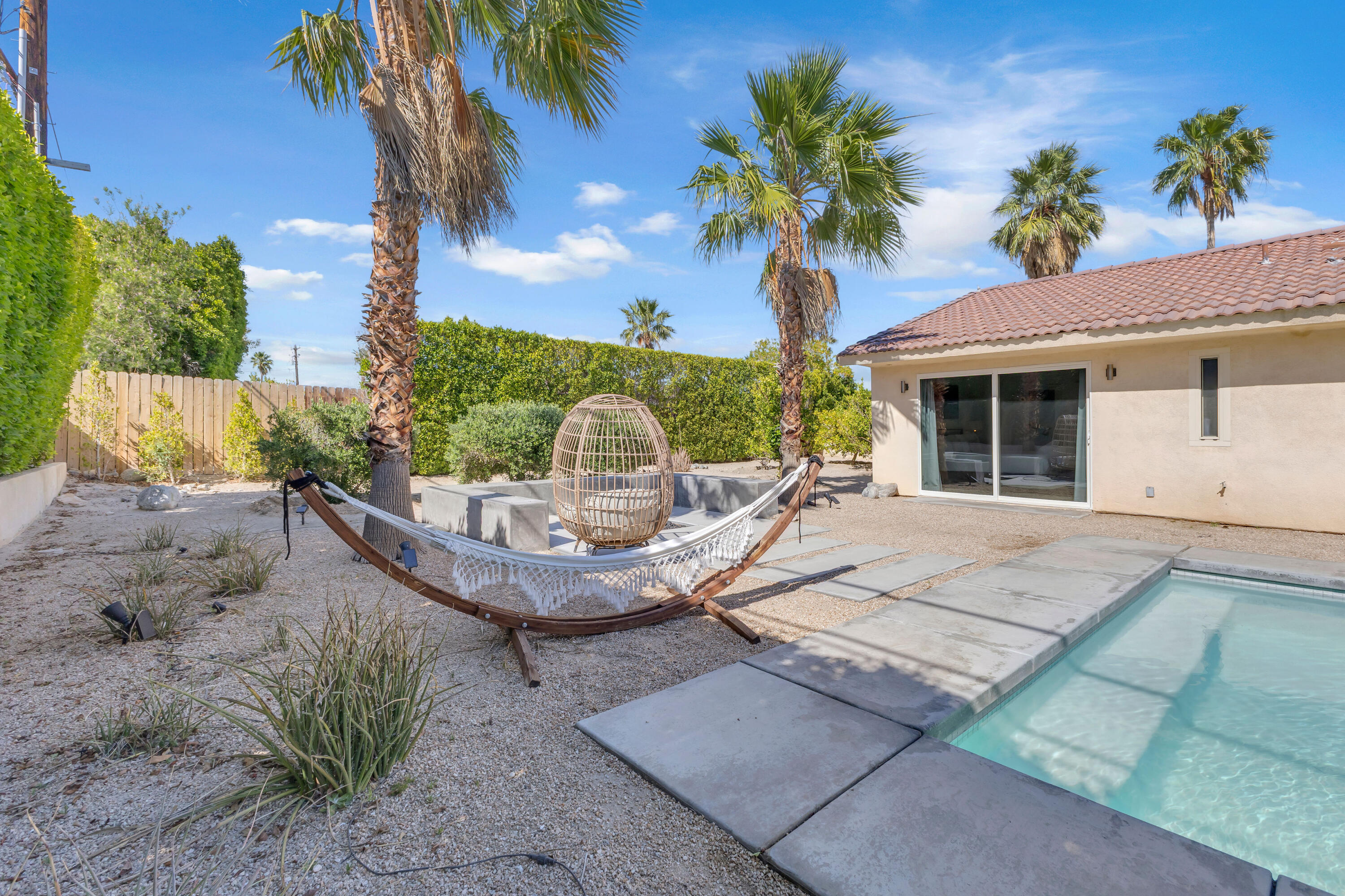 2355 West Nicola Road Palm Springs, CA 92262 - Photo 53 of 54 a view of a house with a swimming pool and a porch