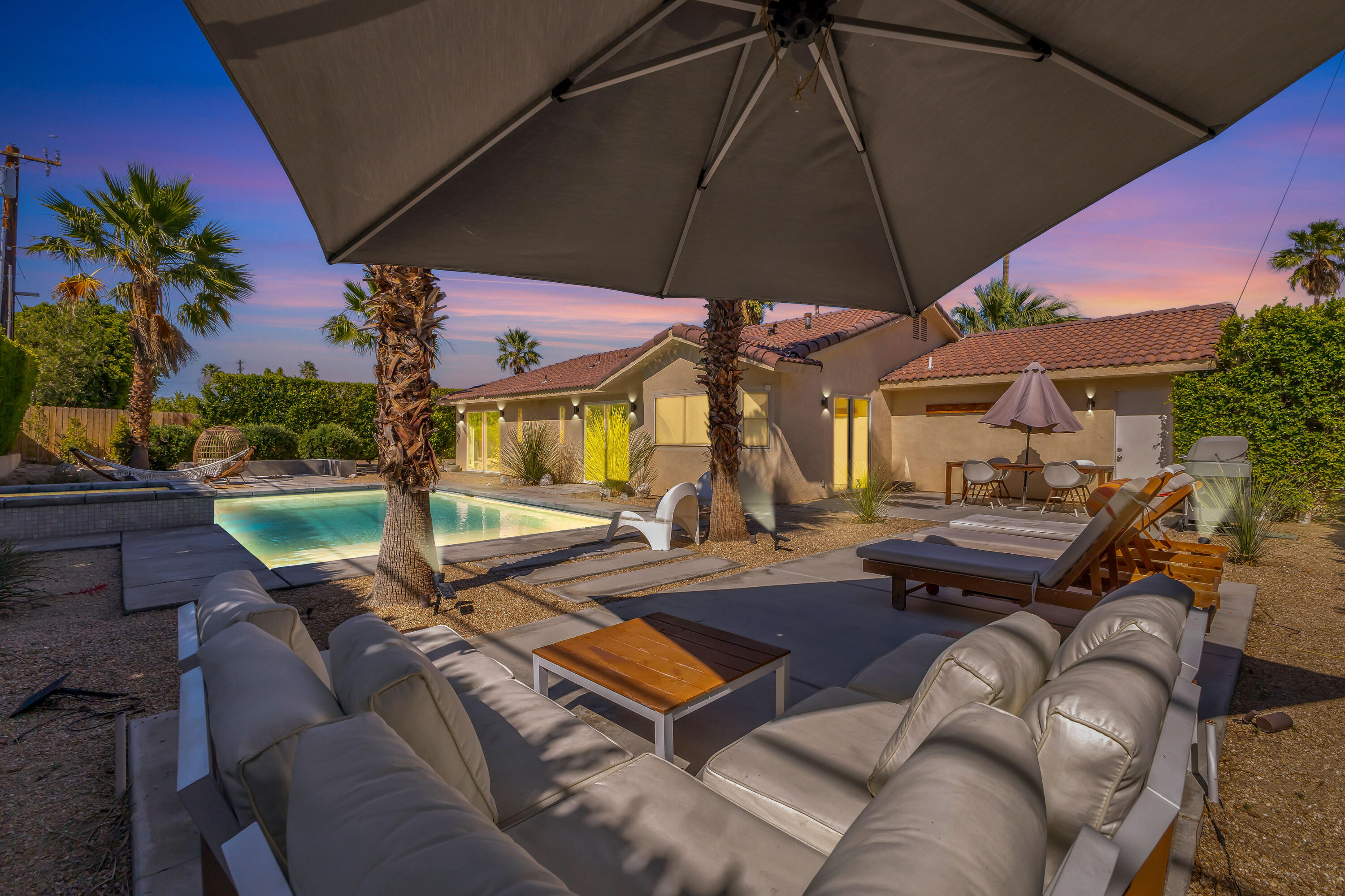 2355 West Nicola Road Palm Springs, CA 92262 - Photo 8 of 54 an outdoor sitting area with furniture and umbrella