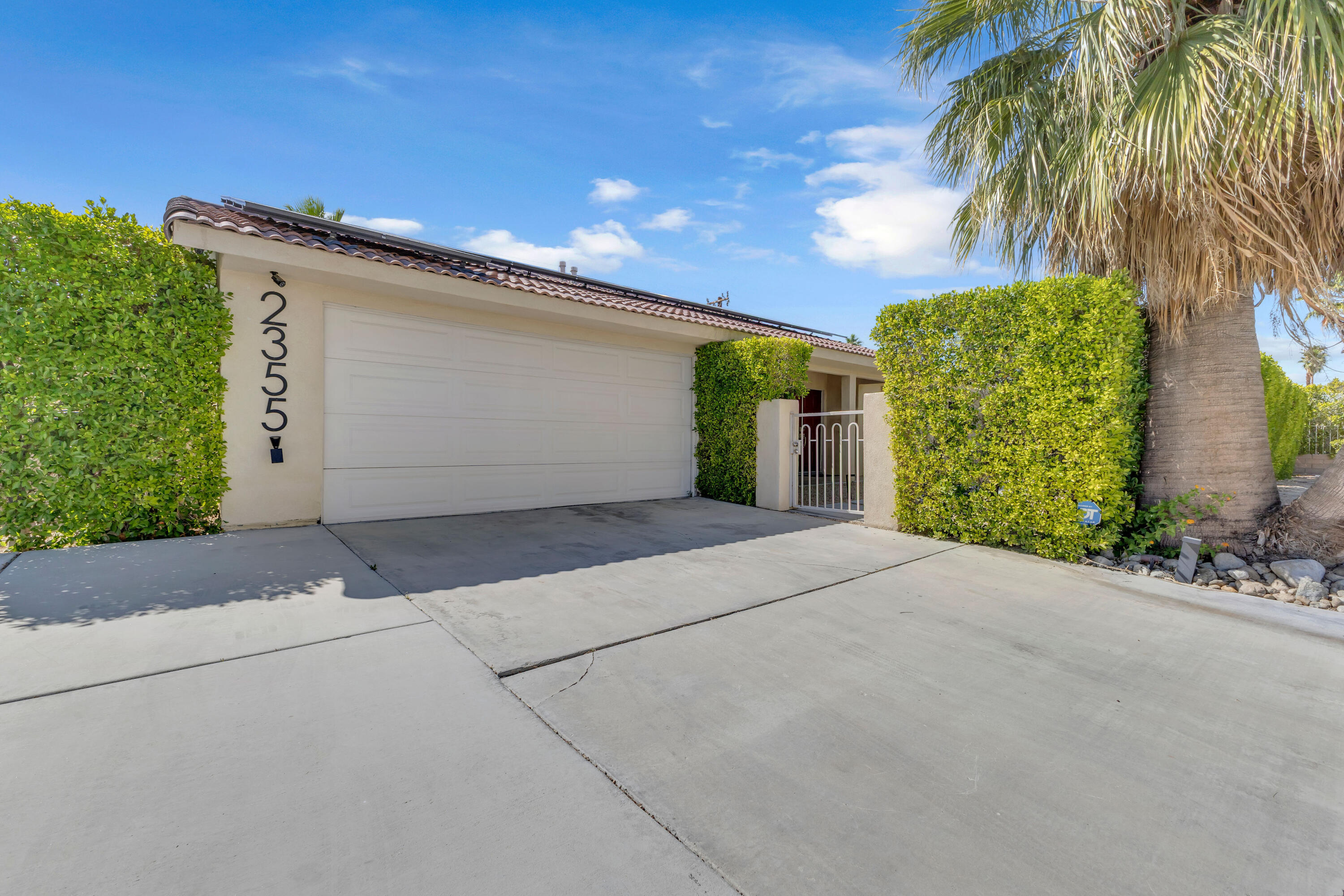 2355 West Nicola Road Palm Springs, CA 92262 - Photo 10 of 54 a front view of a house with a yard and garage