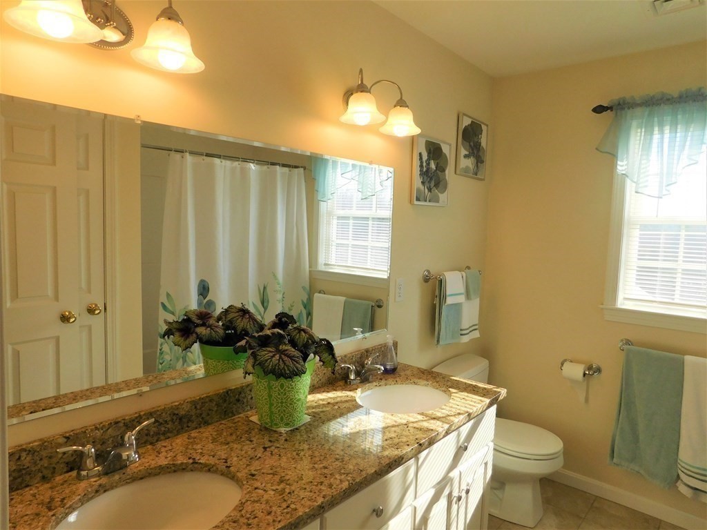 16 Pierce Road Sutton, MA 01590 - Photo 15 of 42 a bathroom with a granite countertop sink and a mirror
