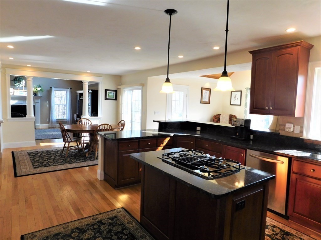 16 Pierce Road Sutton, MA 01590 - Photo 4 of 42 a kitchen with stainless steel appliances a stove a sink a refrigerator wooden floor and white cabinets