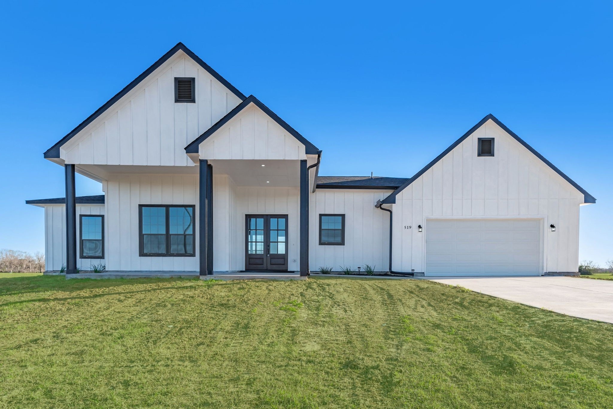 519 Chuckwagon Trail Angleton, TX 77515 - Photo 2 of 34 a front view of a house with large trees