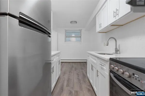 a kitchen with a sink appliances and cabinets