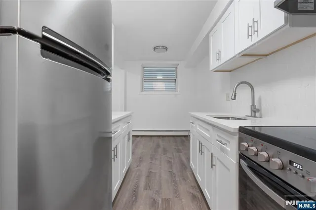 a kitchen with a sink appliances and cabinets